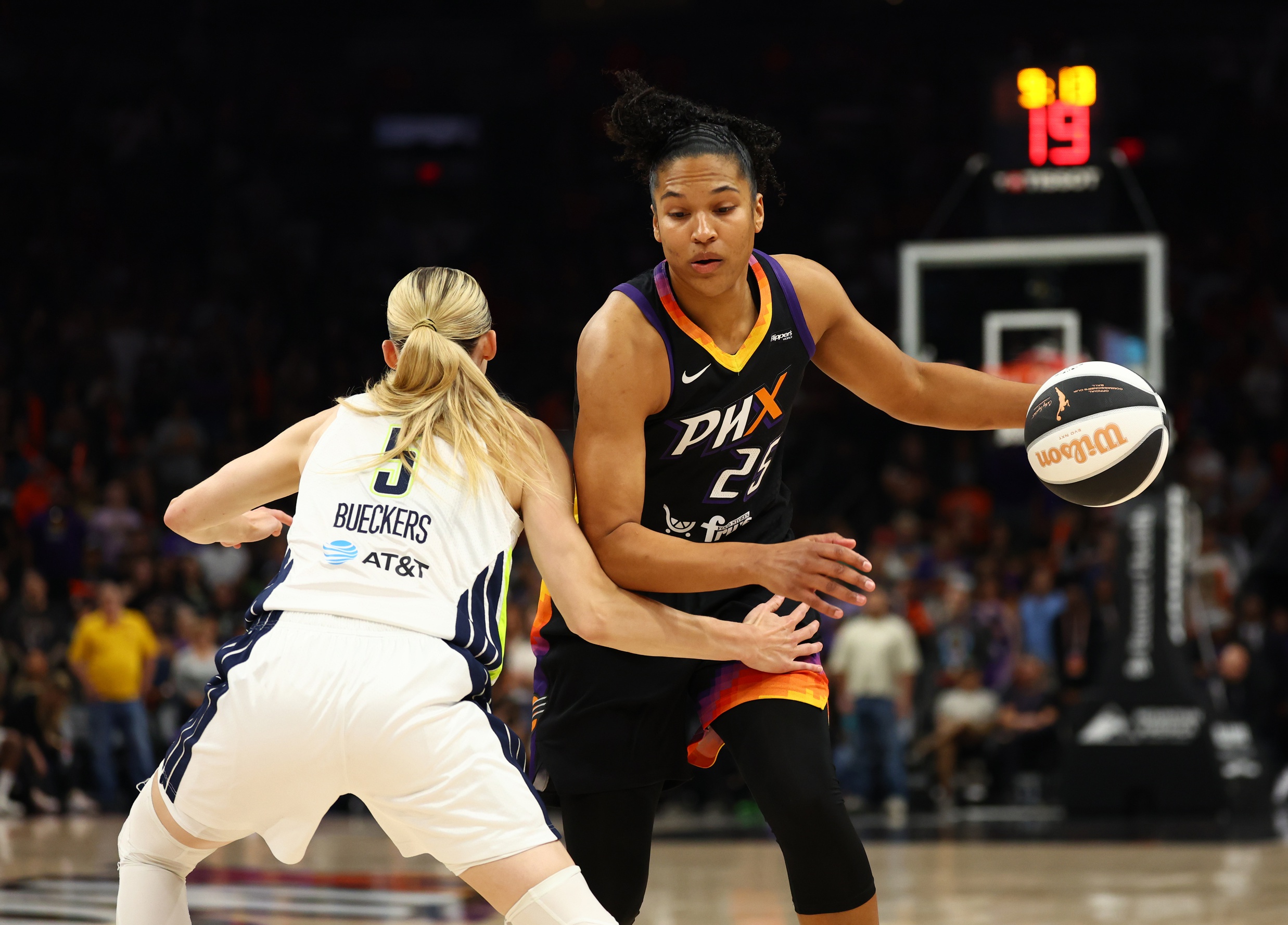 Paige Bueckers (5) defends Alyssa Thomas (25) while Thomas dribbles the ball