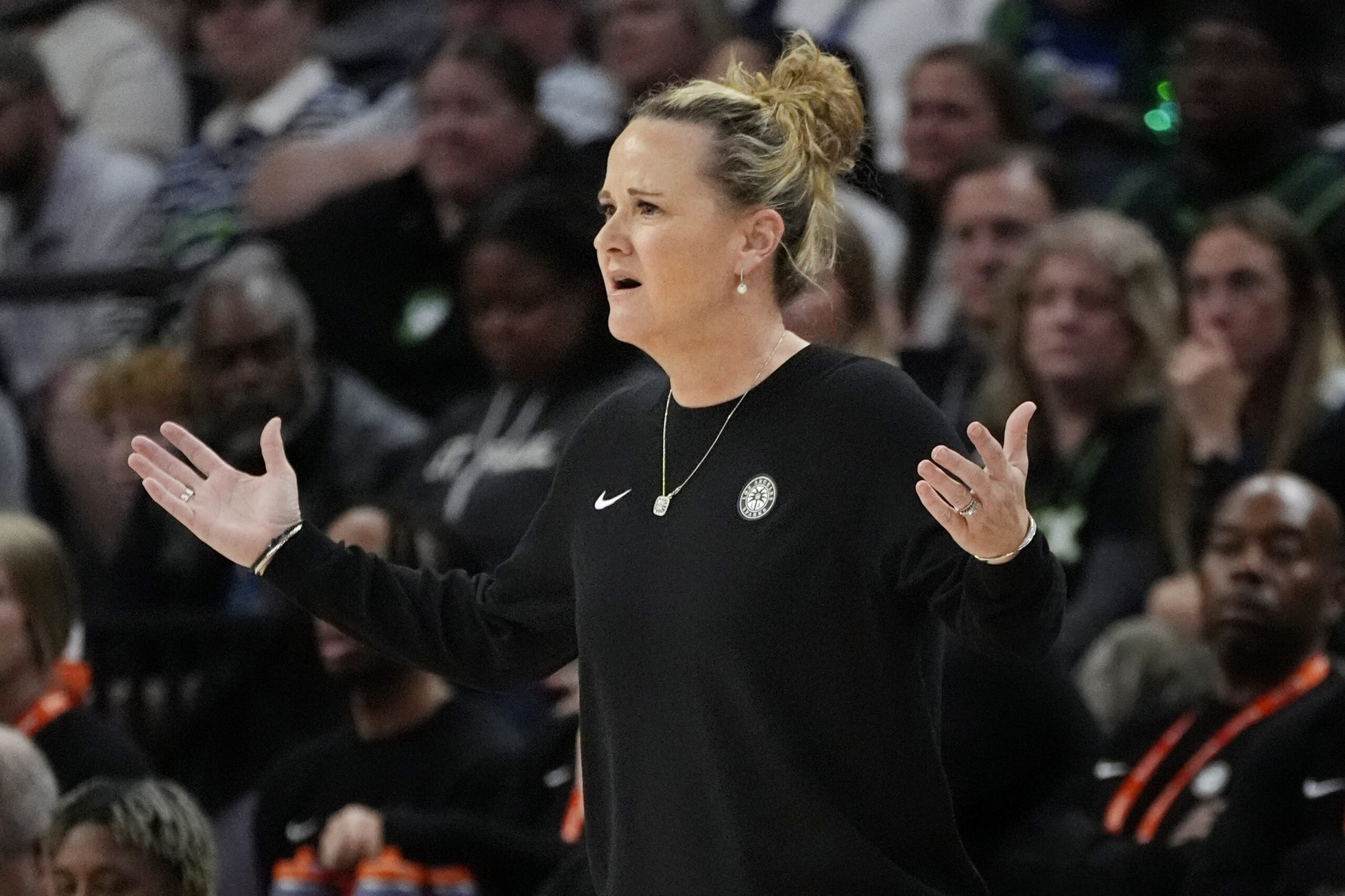 Sparks Head Coach Lynne Roberts holds two hands up, looking confused, in a previous matchup against the Minnesota Lynx on June 14.