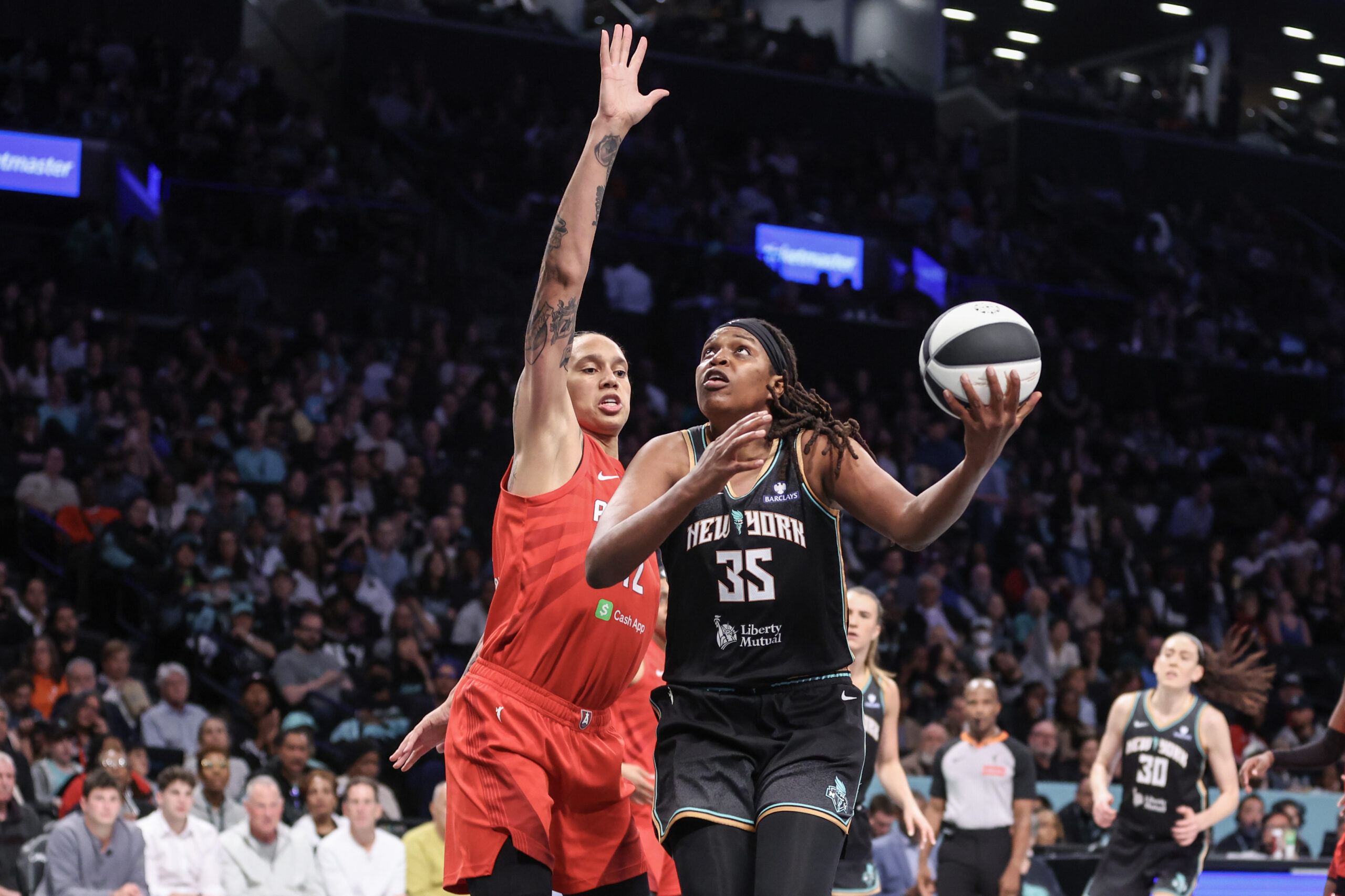 Jonquel Jones looks to score with Brittney Griner trying to contest her at the rim