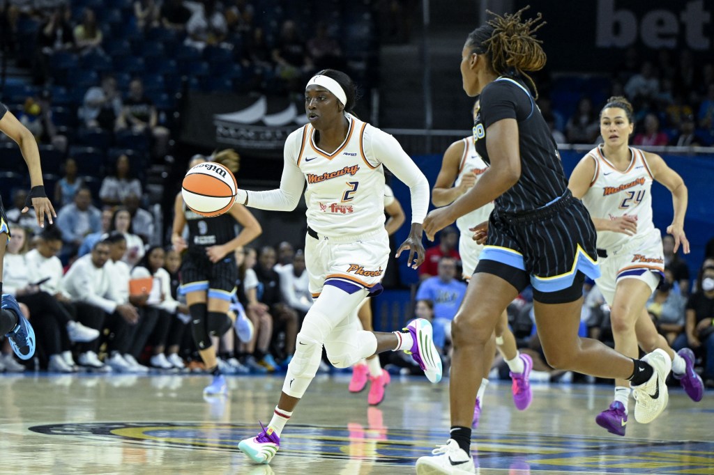 Kahleah Copper (2) dribbles down the court while a Chicago Sky player runs alongside her