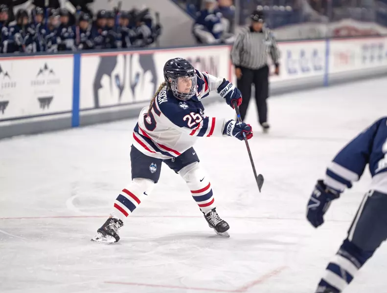 Jada Habisch of the University of Connecticut saucers a pass across the ice.