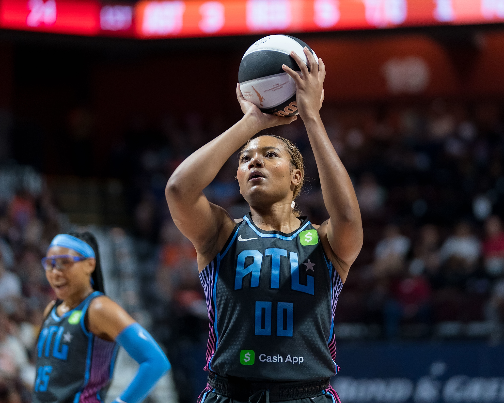 Atlanta Dream forward Naz Hillmon shoots a free throw while Atlanta Dream guard Allisha Gray stands in the background with her hands on her hips