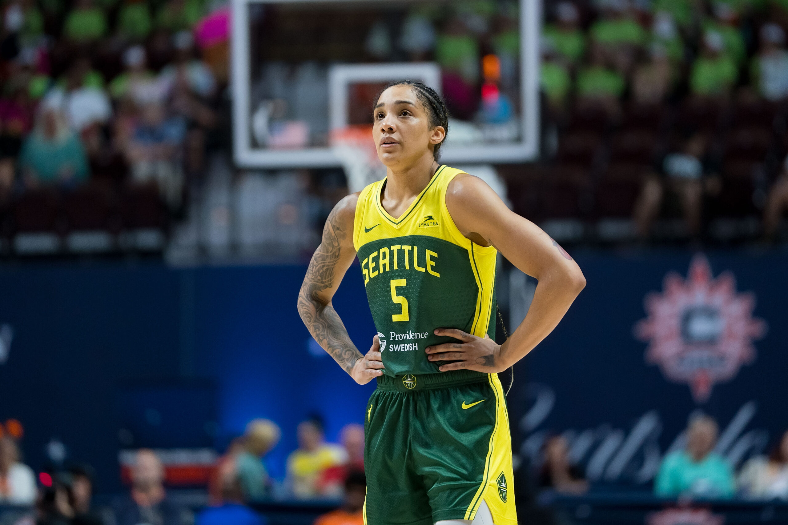 Gabby Williams stands with arms on hips during a WNBA basketball game