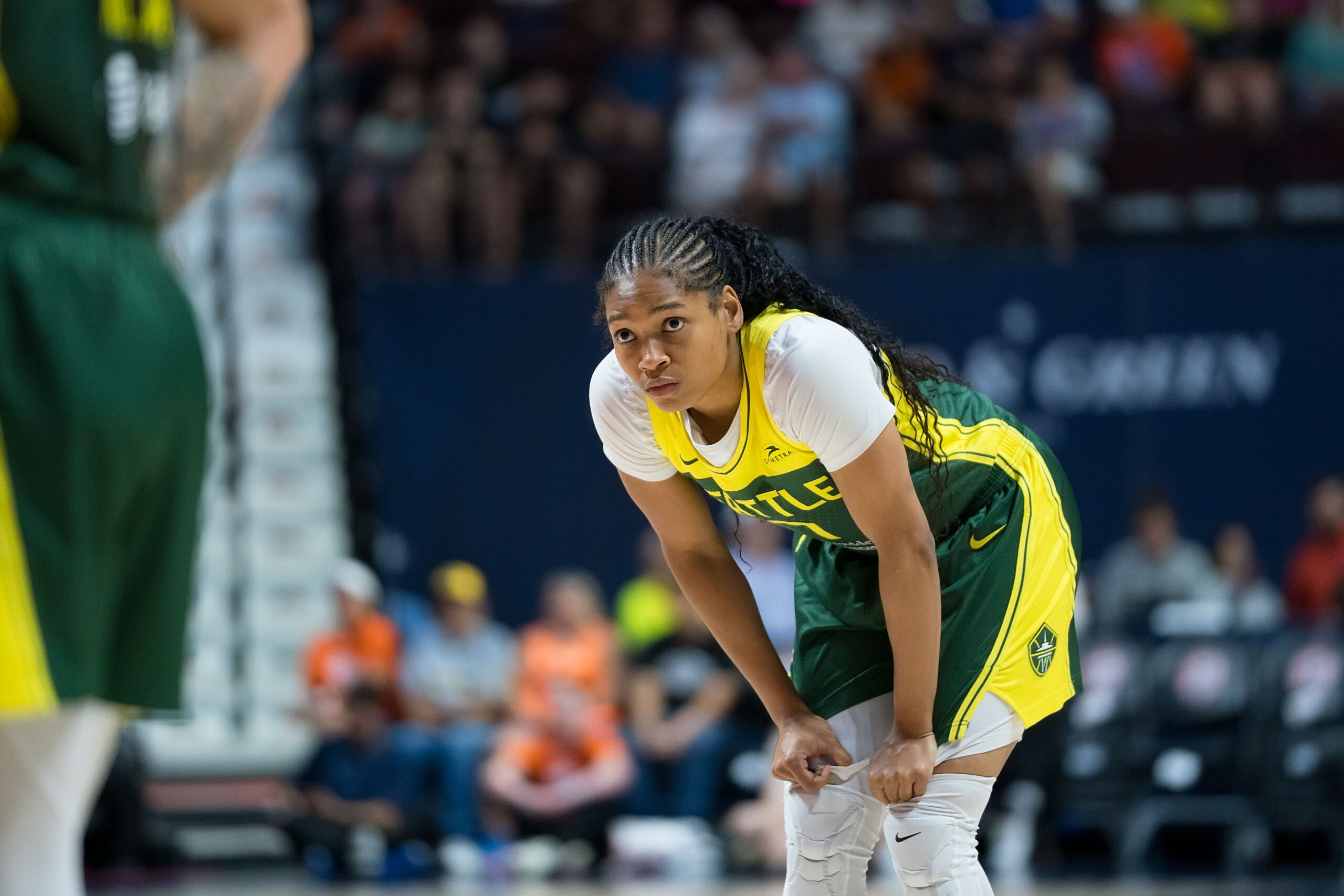 Seattle Storm guard Zia Cooke stands with her hands on her knees gripping her shorts during the WNBA game between the Seattle Storm and the Connecticut Sun at Mohegan Sun Arena, Uncasville, Connecticut, on July 9, 2025.