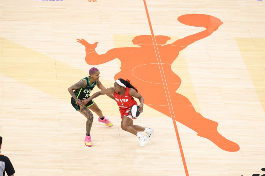 Aari McDonald (right) drives against Minnesota's Courtney Williams in the recent WNBA Commissioner's Cup contest.