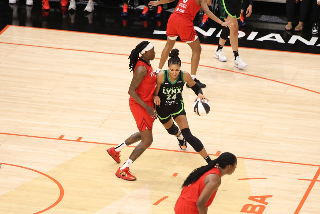 Indiana Fever forward Natasha Howard defends Minnesota Lynx star Napheesa Collier while she dribbles the ball