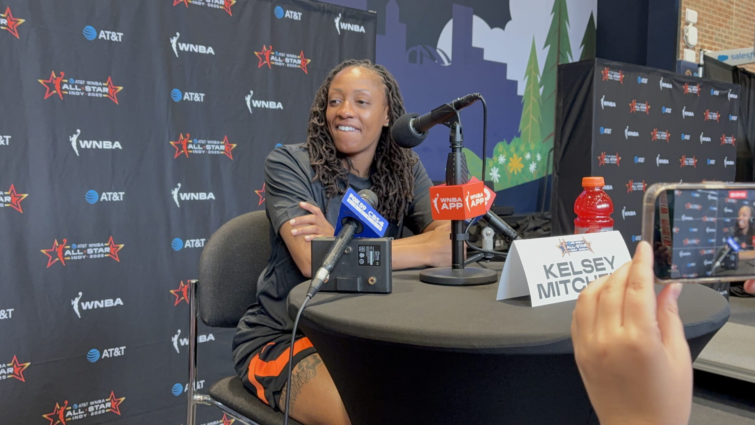 Indiana Fever guard Kelsey Mitchell All-Star sits at a table for media availability