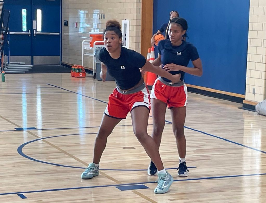 Success Prysock (left) and Tiyanna James (right) battle during a boxing out drill during practice.