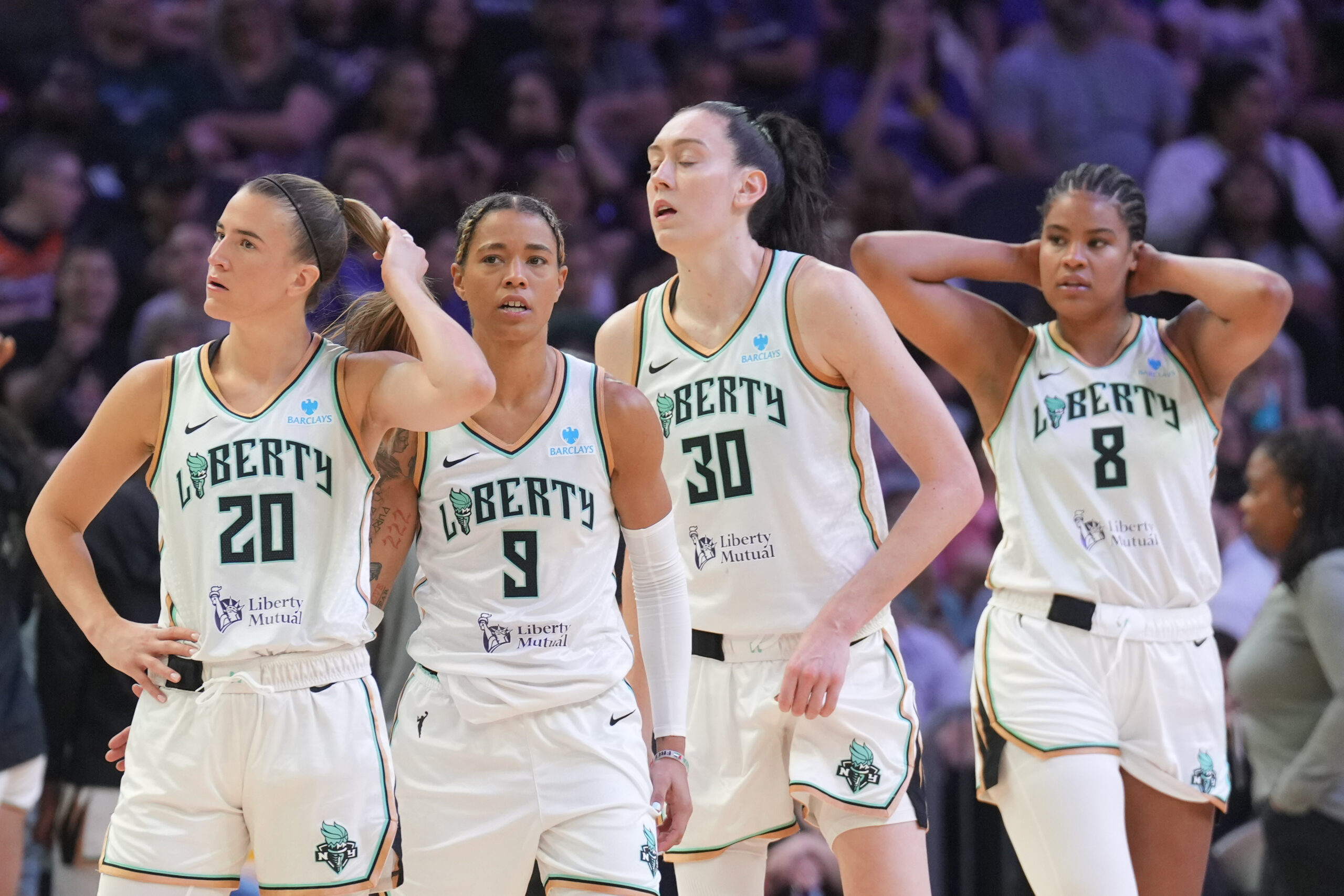 Sabrina Ionescu, Natasha Cloud, Breanna Stewart and Nyara Sabally stand together with frustration on their faces while playing the Phoenix Mercury.