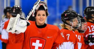 Switzerland's Florence Schelling salutes the crowd wearing a Swiss hockey uniform