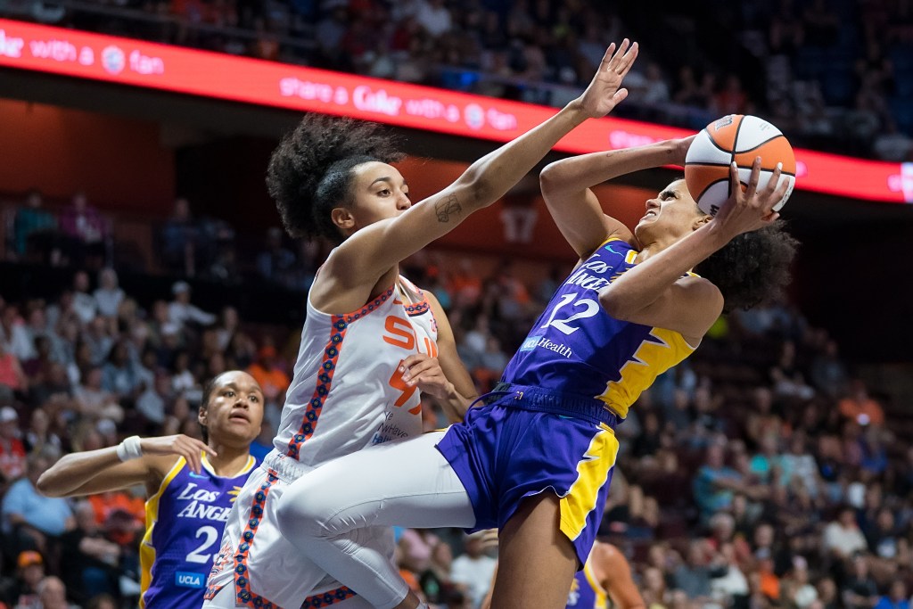 Leïla Lacan with her arm in her defenders face.