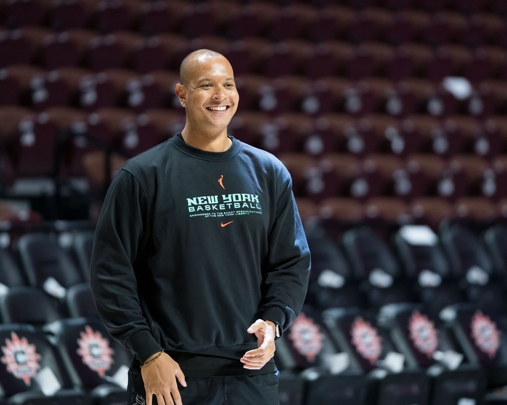 New York Liberty Director of Player Development Andrew Wade smiles wide during pre-game warmups.