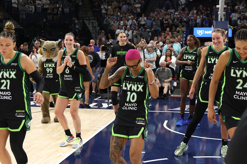 Lynx players, and Prowl, dance after a win.