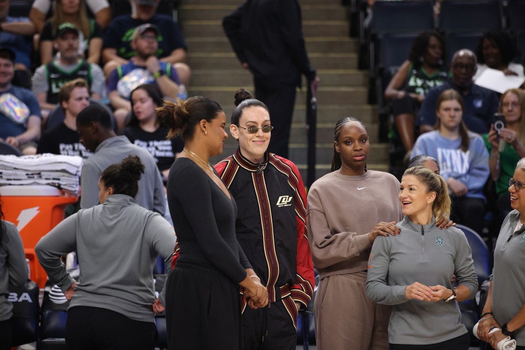 Nyara Sabally, Breanna Stewart and Kennedy Burke stand together in street clothes as the three Liberty players who have been out with injury.