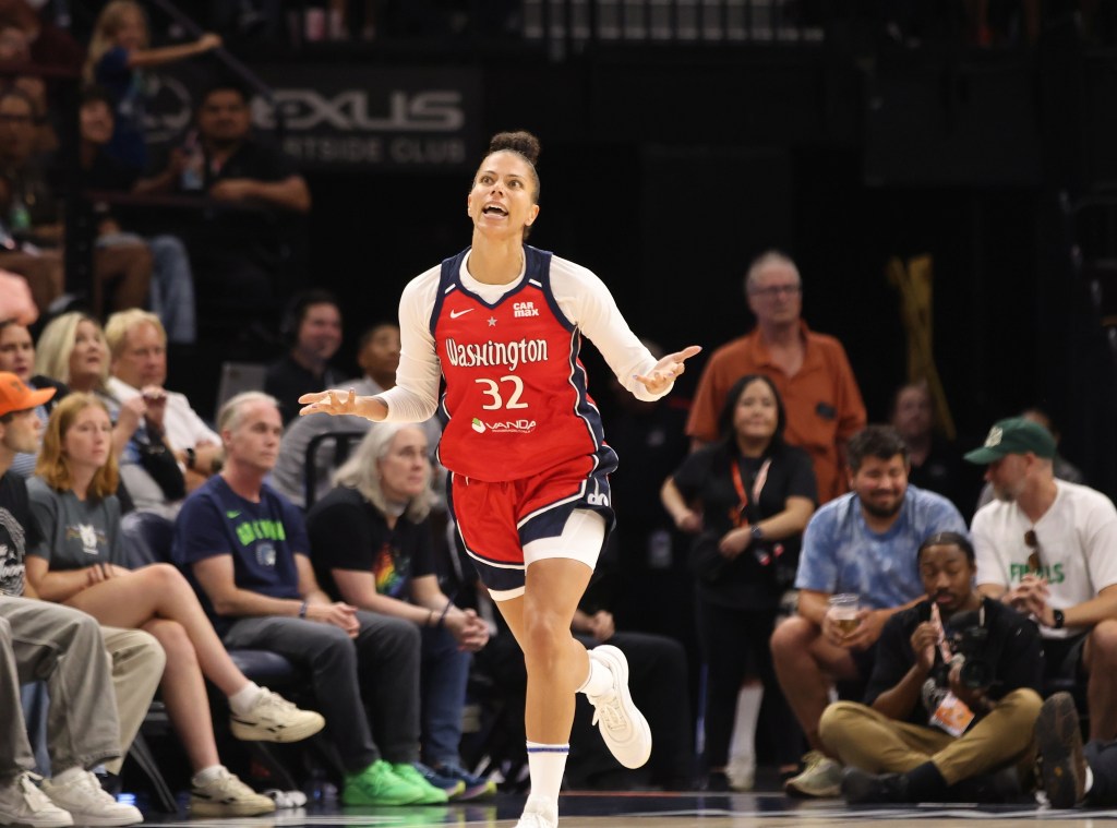 Washington Mystics forward Alysha Clark turns her palms upward and looks up in relief as she runs back on defense after making a 3-pointer.