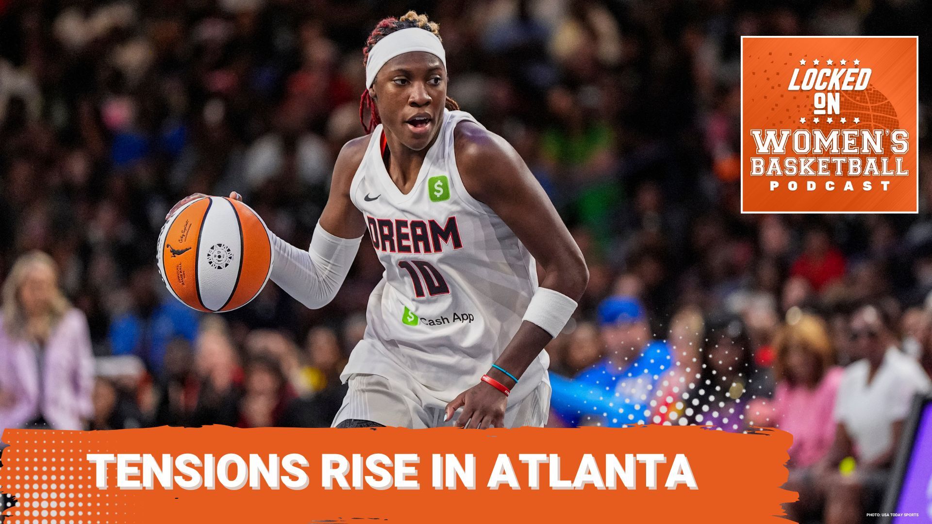 Atlanta Dream guard Rhyne Howard dribbles the basketball wearing a white Dream jersey and headband as she looks away from the camera.