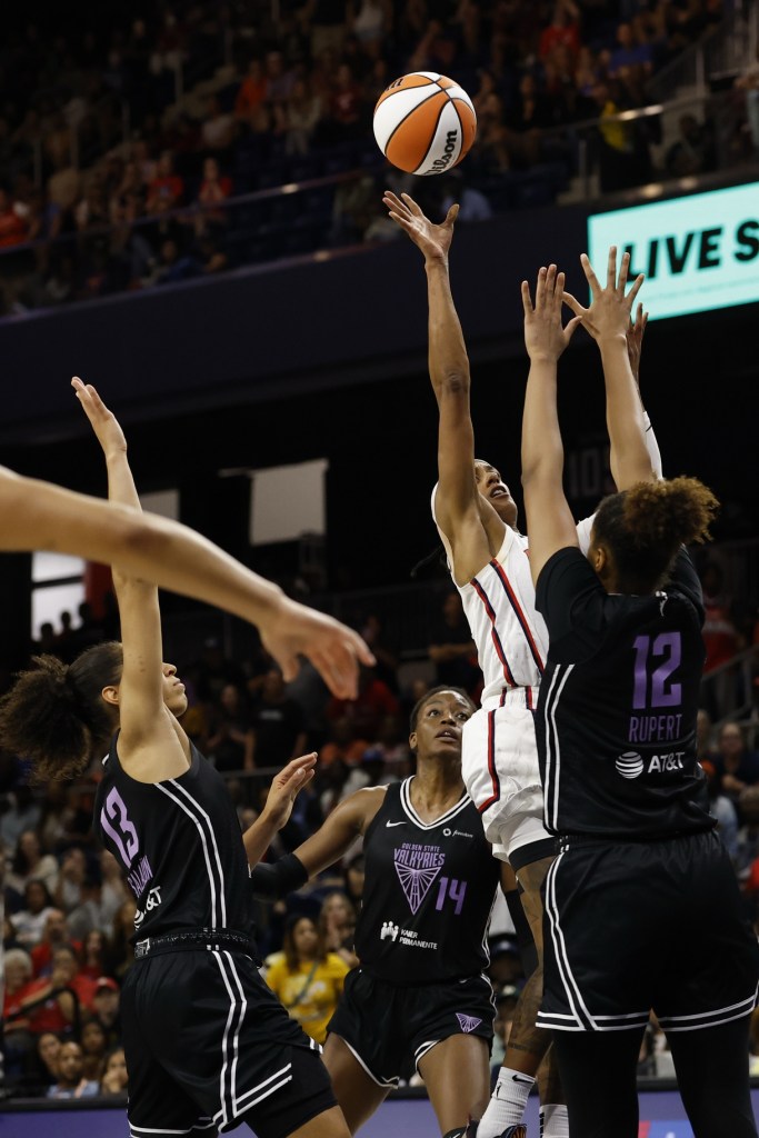 Washington Mystics guard Brittney Sykes attempts a floater as Golden State Valkyries forward Iliana Rupert puts her arms straight up to contest the shot.