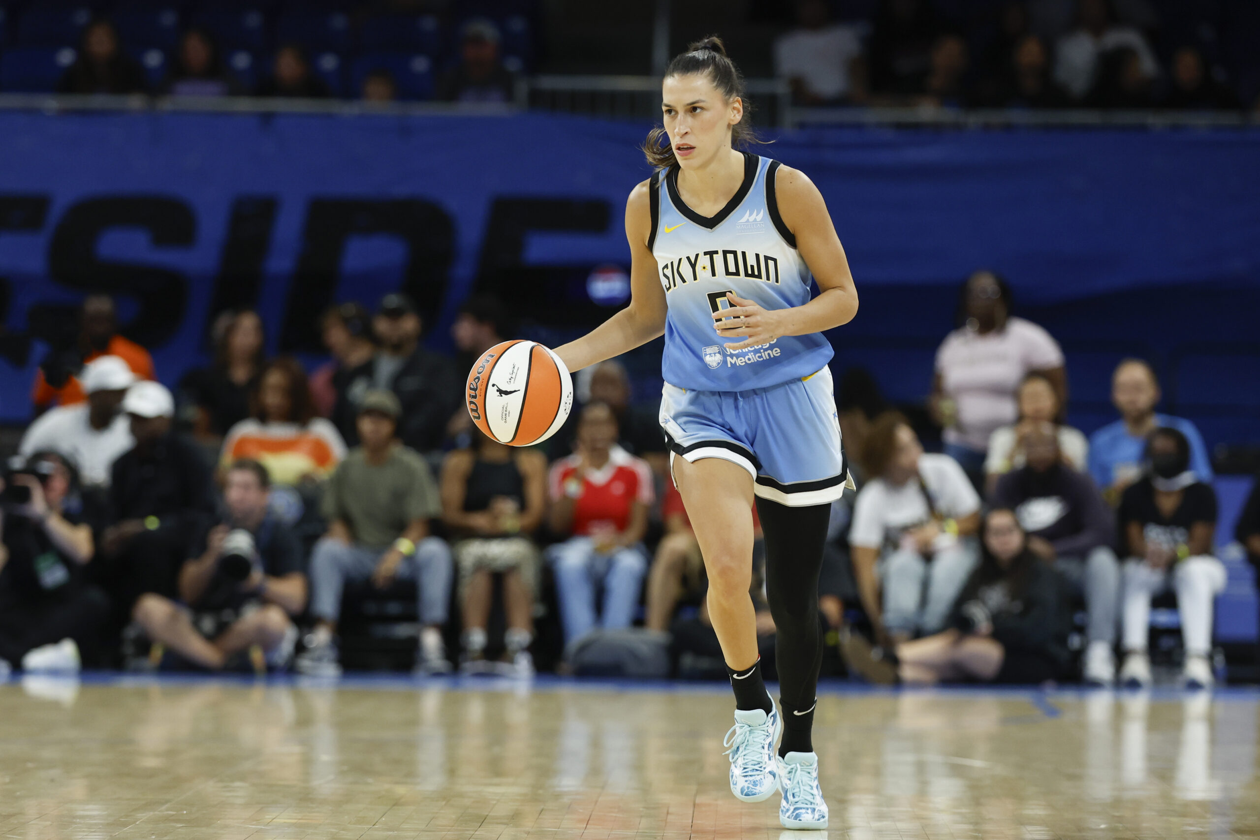 Sky guard Sevgi Uzun, wearing a Chicago Sky uniform, brings the ball up the court