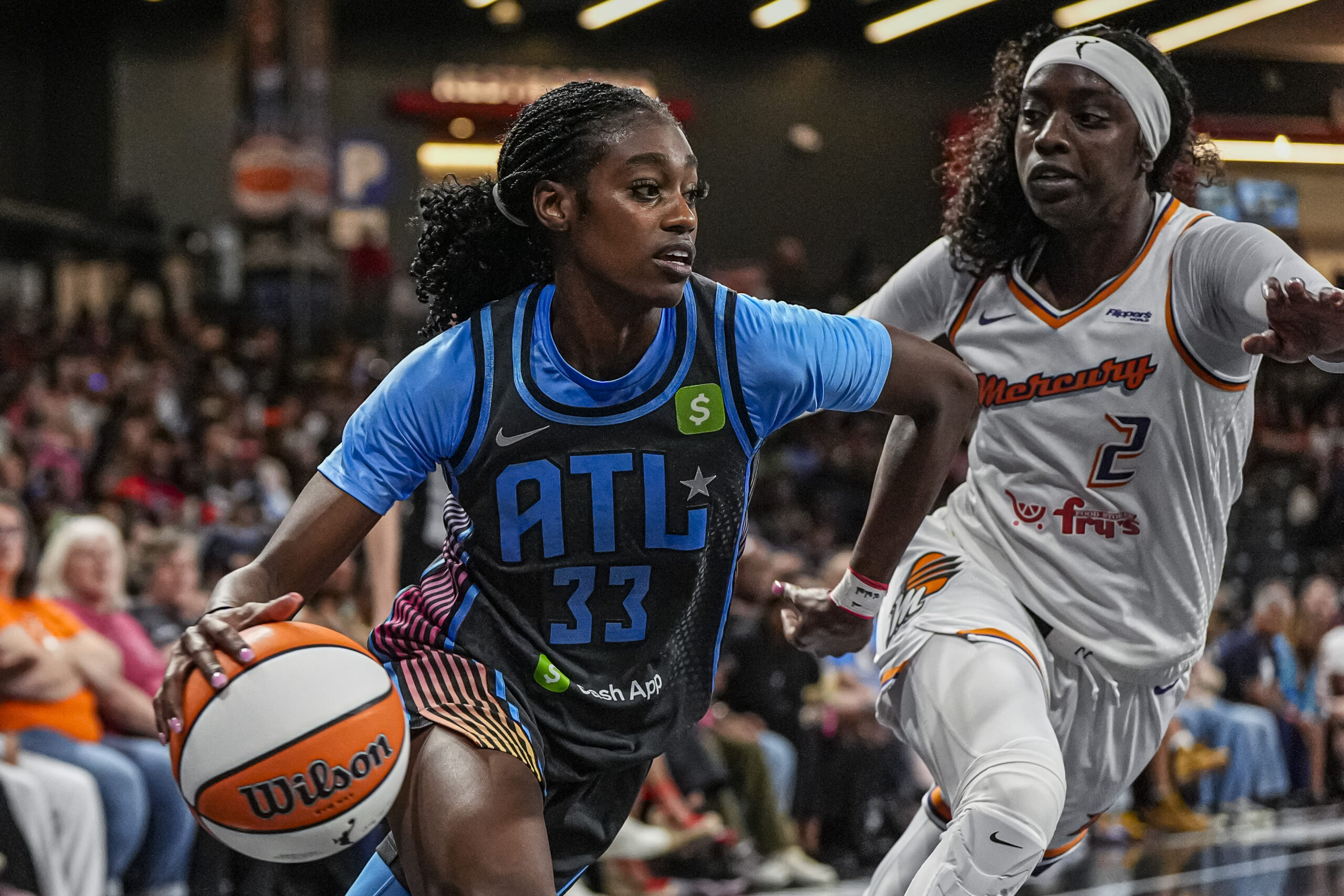 Atlanta Dream guard Maya Caldwell (33) dribbles alongside Phoenix's Kahleah Copper (2)
