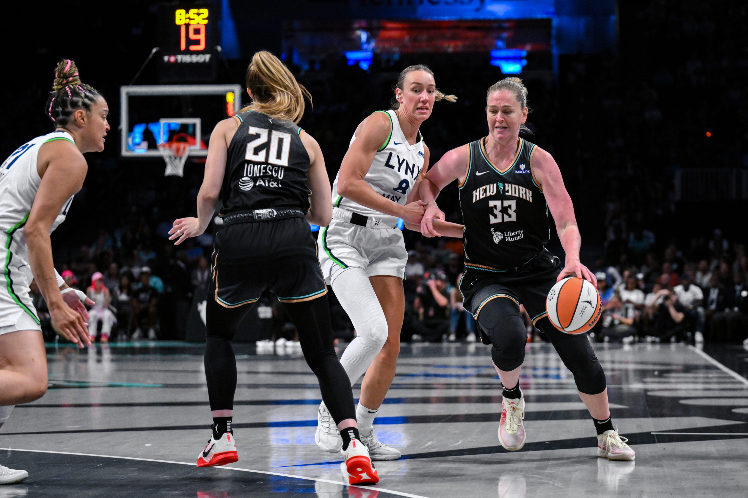 Emma Meesseman and Sabrina Ionescu work in the two-woman game against the Lynx