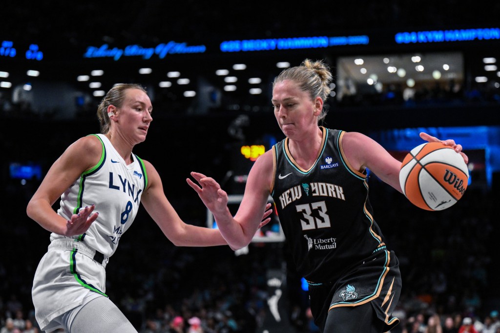 Emma Meesseman drives the ball while a player from the Lynx challenges her