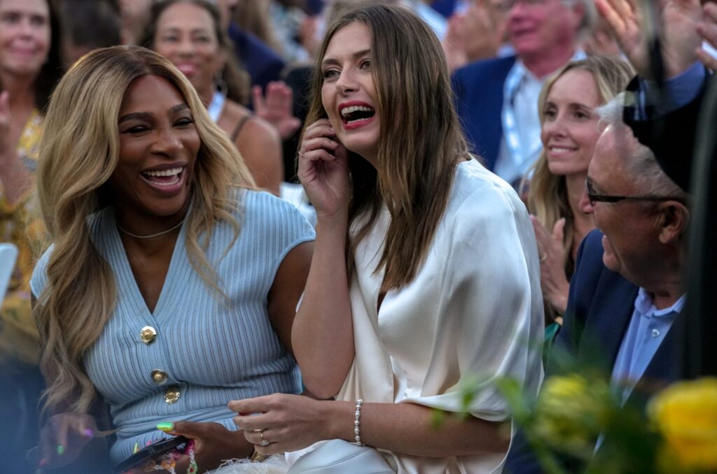 Serena Williams and Maria Sharapova laugh at the 2025 International Tennis Hall of Fame ceremony.