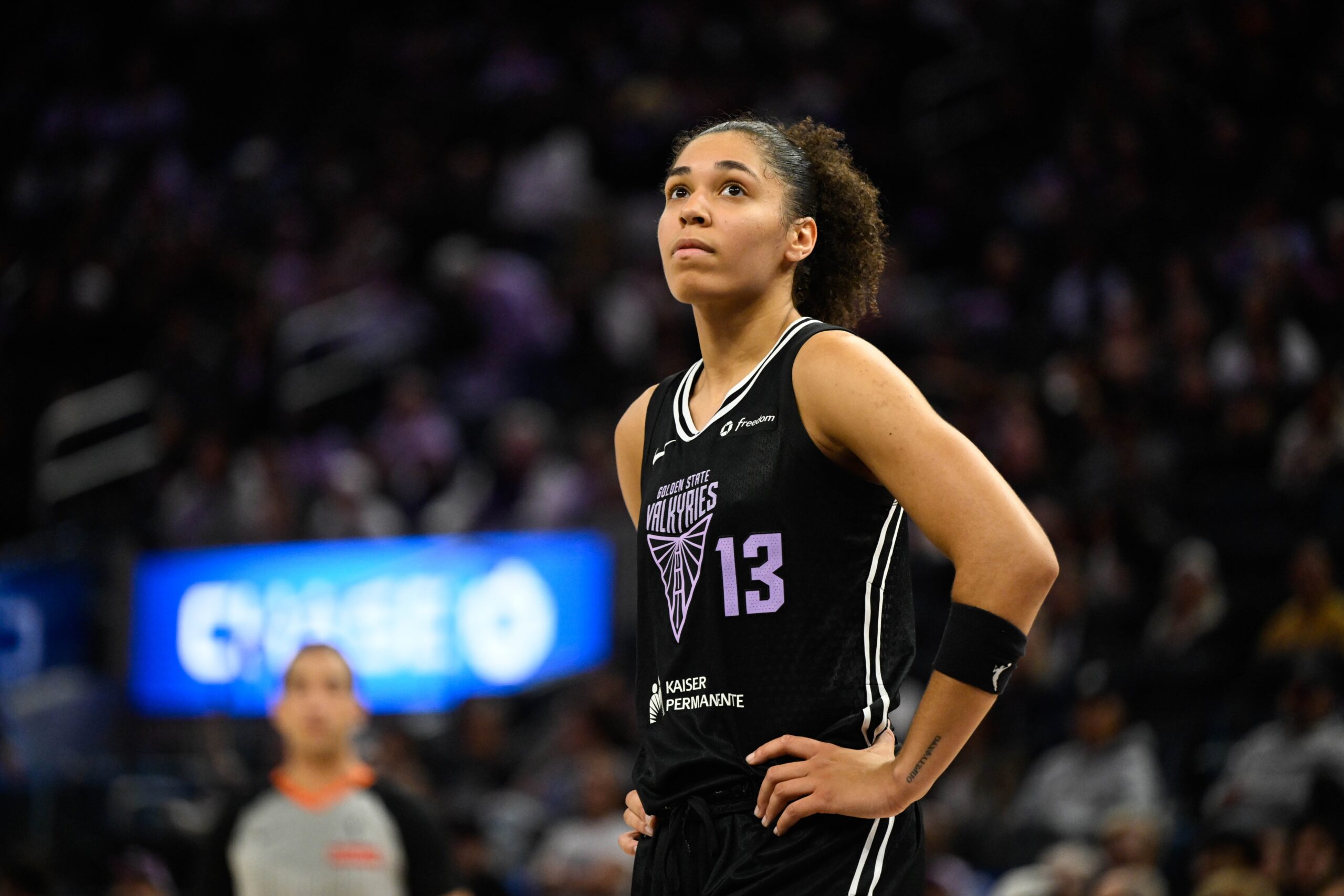Valkyries Forward Janelle Salaun looks out at the crowd. She is shown from the front with a large but out of focus crowd behind her.