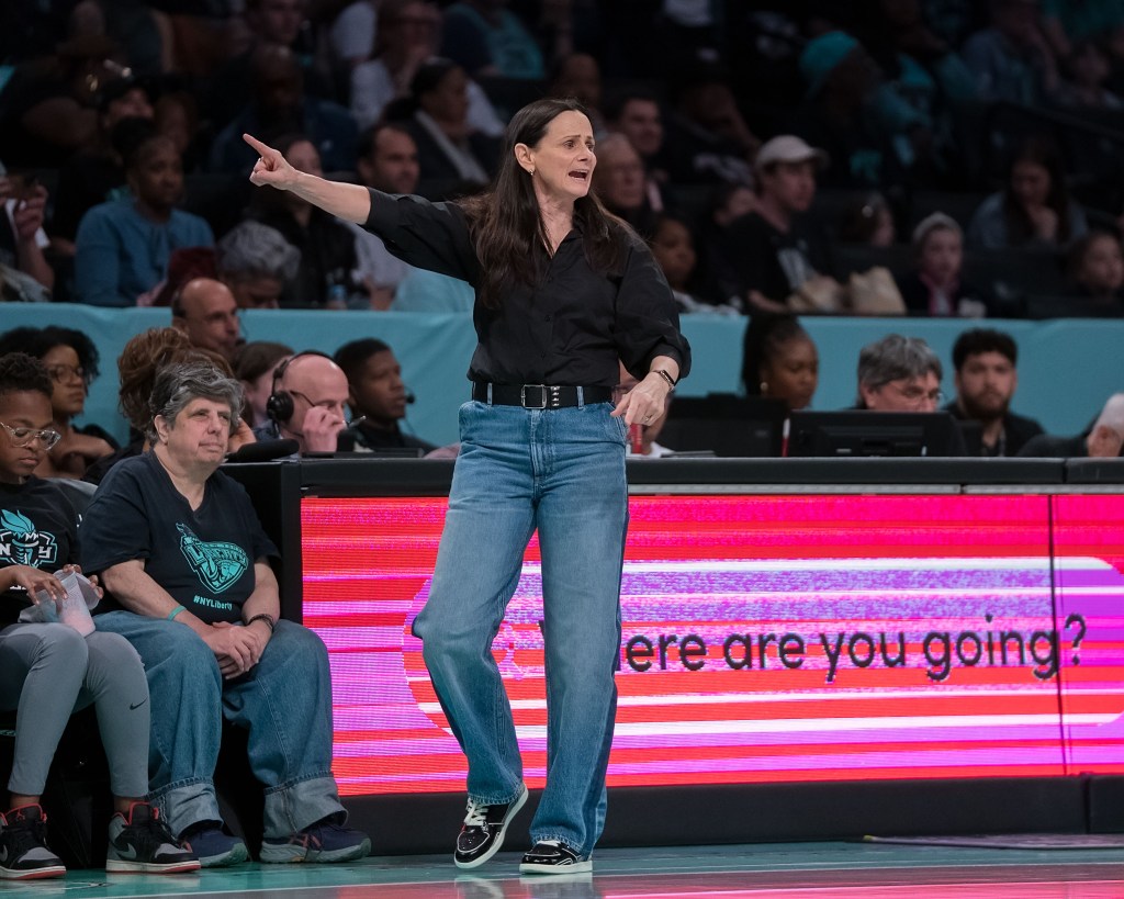 New York Liberty head coach Sandy Brondello points her finger while she walks along the sideline during a game.