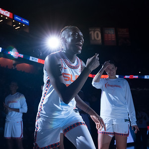 Saniya Rivers smiles during player introductions as a light shines on her off to the left behind her head.