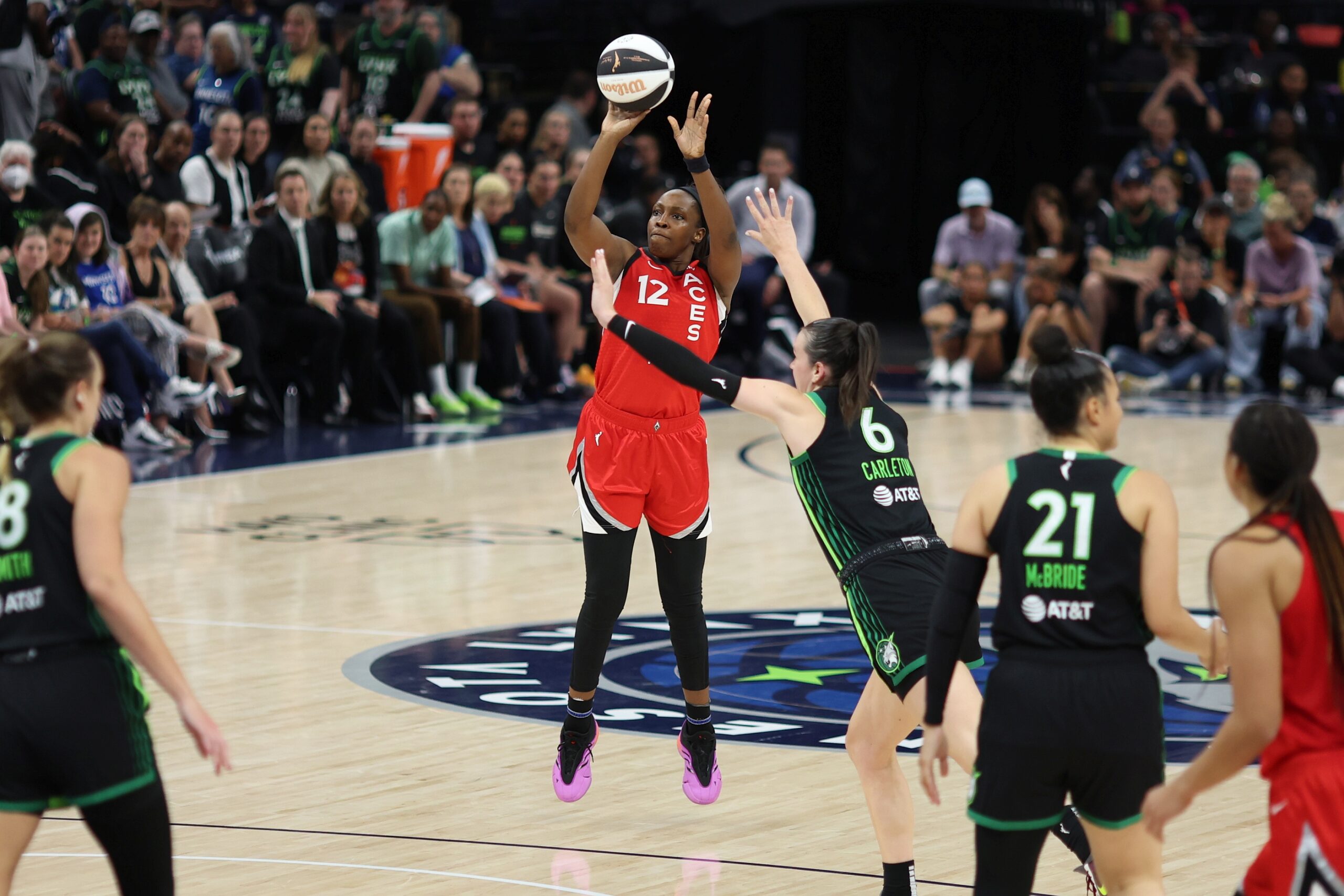 Aces guard Chelsea Gray (12) shoots the ball from the three-point line over Lynx wing Bridget Carleton (6) during a game at the Target Center.