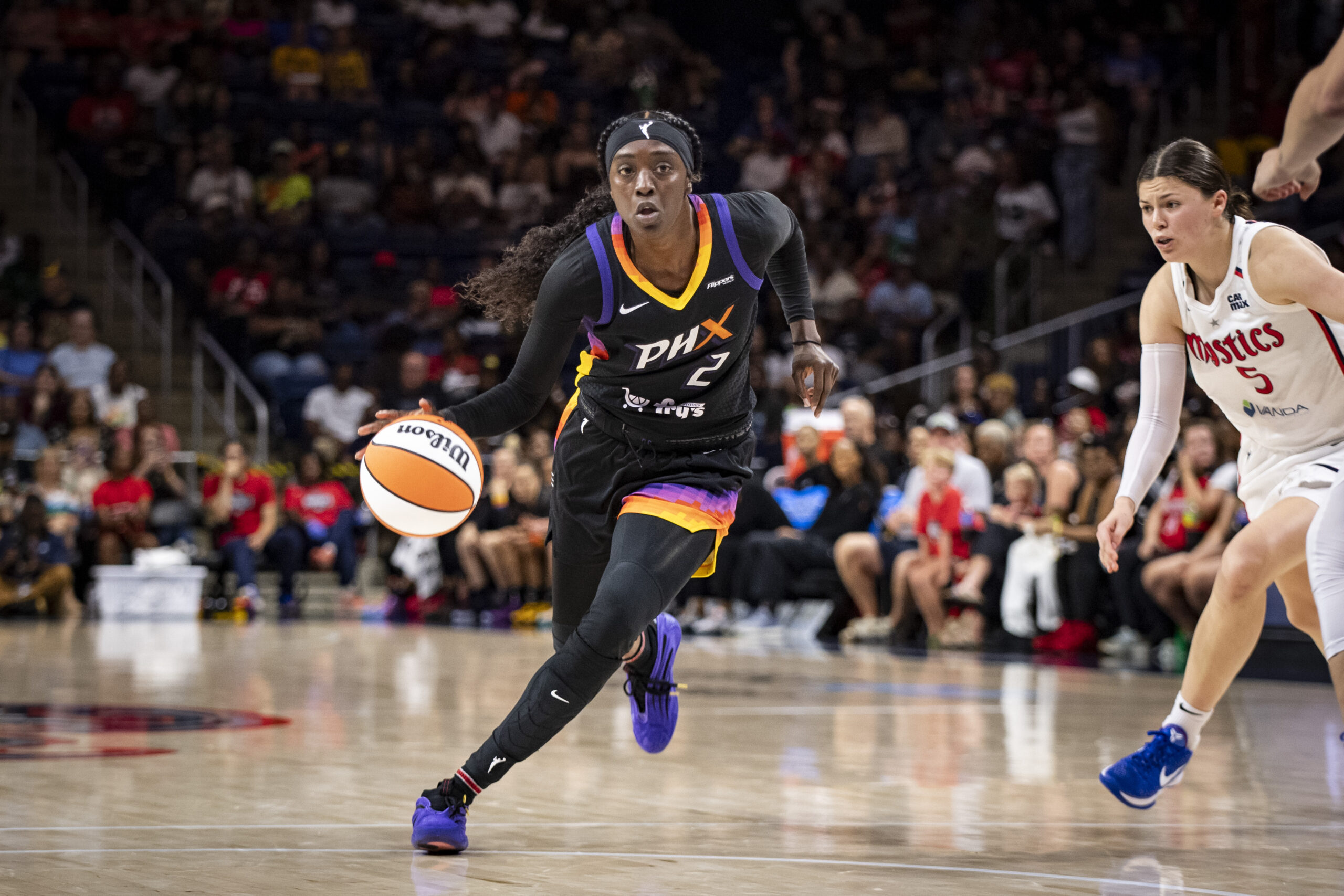 Mercury wing Kahleah Copper drives to the basket with a Mystics defender trailing behind her