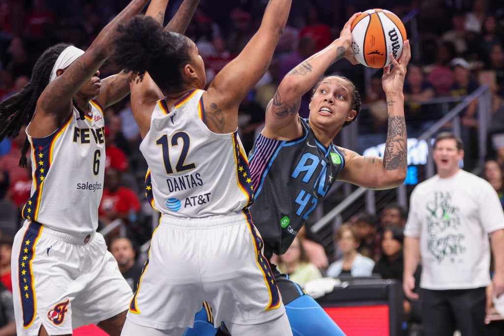 Two Indiana Fever players wall up against Atlanta Dream center Brittney Griner, who looks to take an off-balance shot.