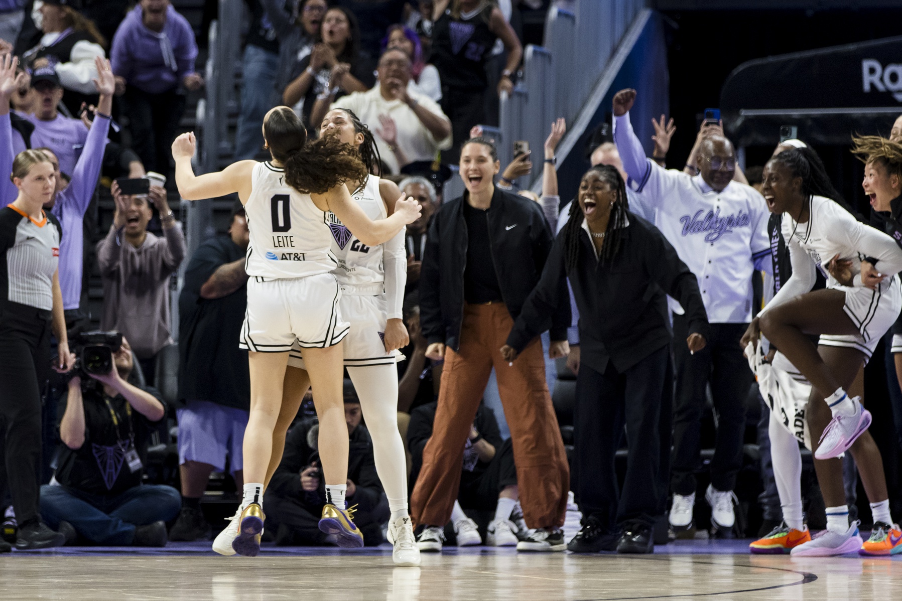 Golden State Valkyries guard Veronica Burton and guard Carla Leite and other players celebrate a big play. They are shown from the front.