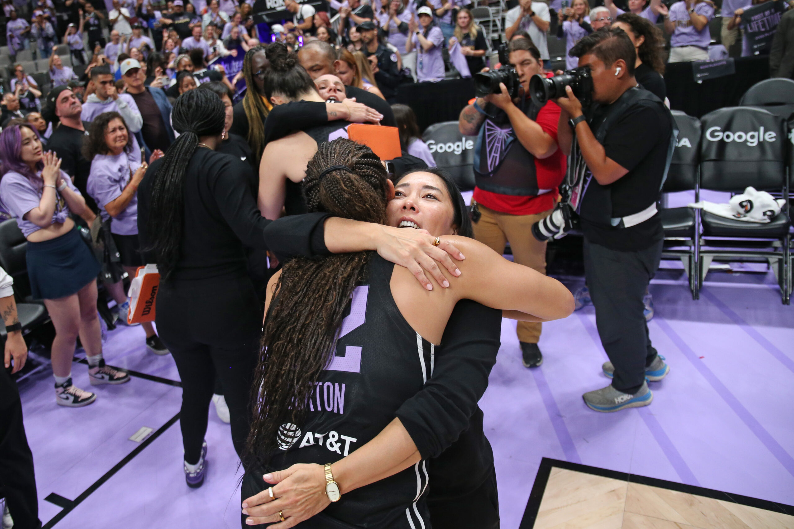 Valkyries coach Natalie Nakase embraces guard Veronica Burton following the Valkyries season-ending loss to Minnesota in the WNBA playoffs.