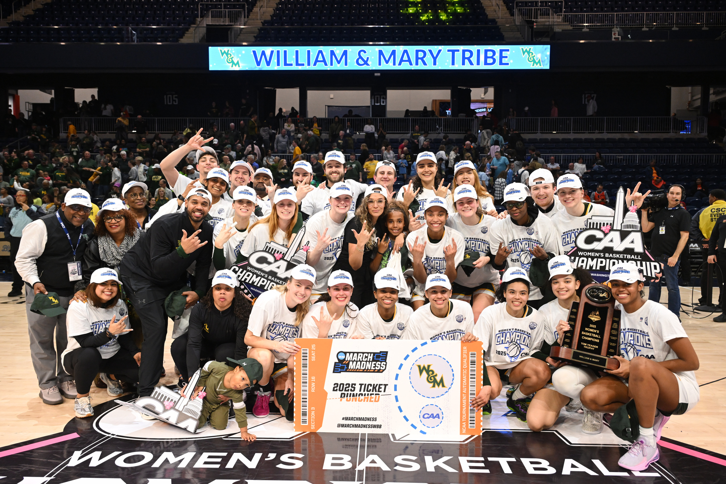 William & Mary celebrates the 2025 CAA Tournament championship with a group photo.