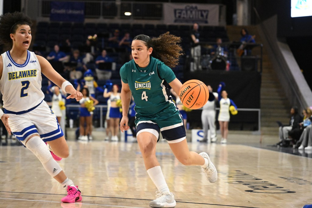 UNCW guard Tia Dobson dribbles the ball up the floor in a game against Delaware.