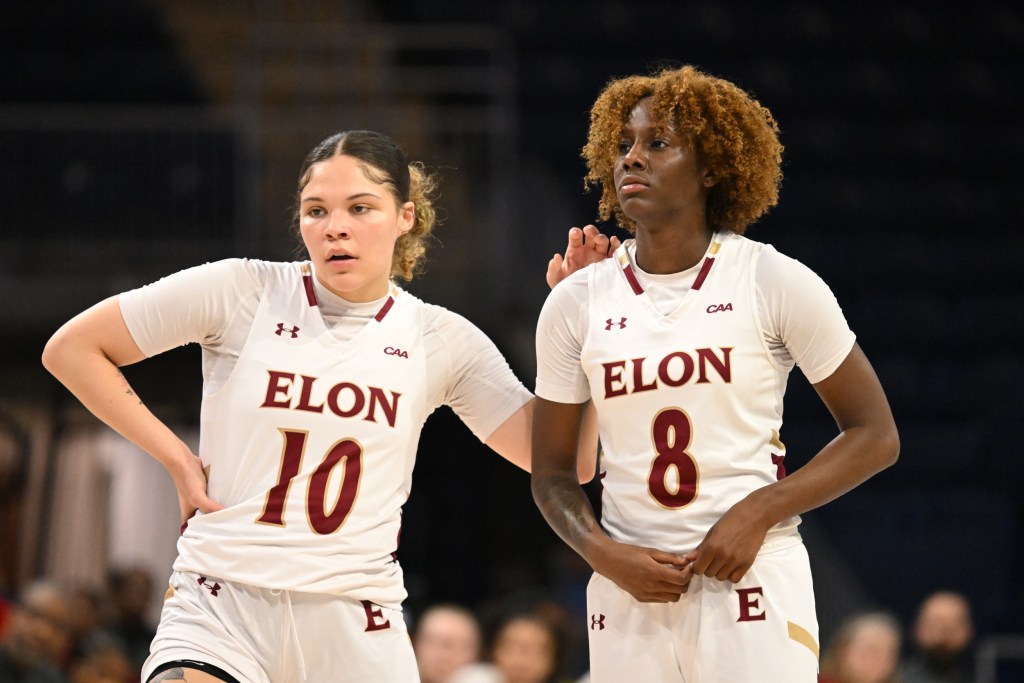 Elon's Kamryn Doty and Jayda Angel during a break during a game talk.