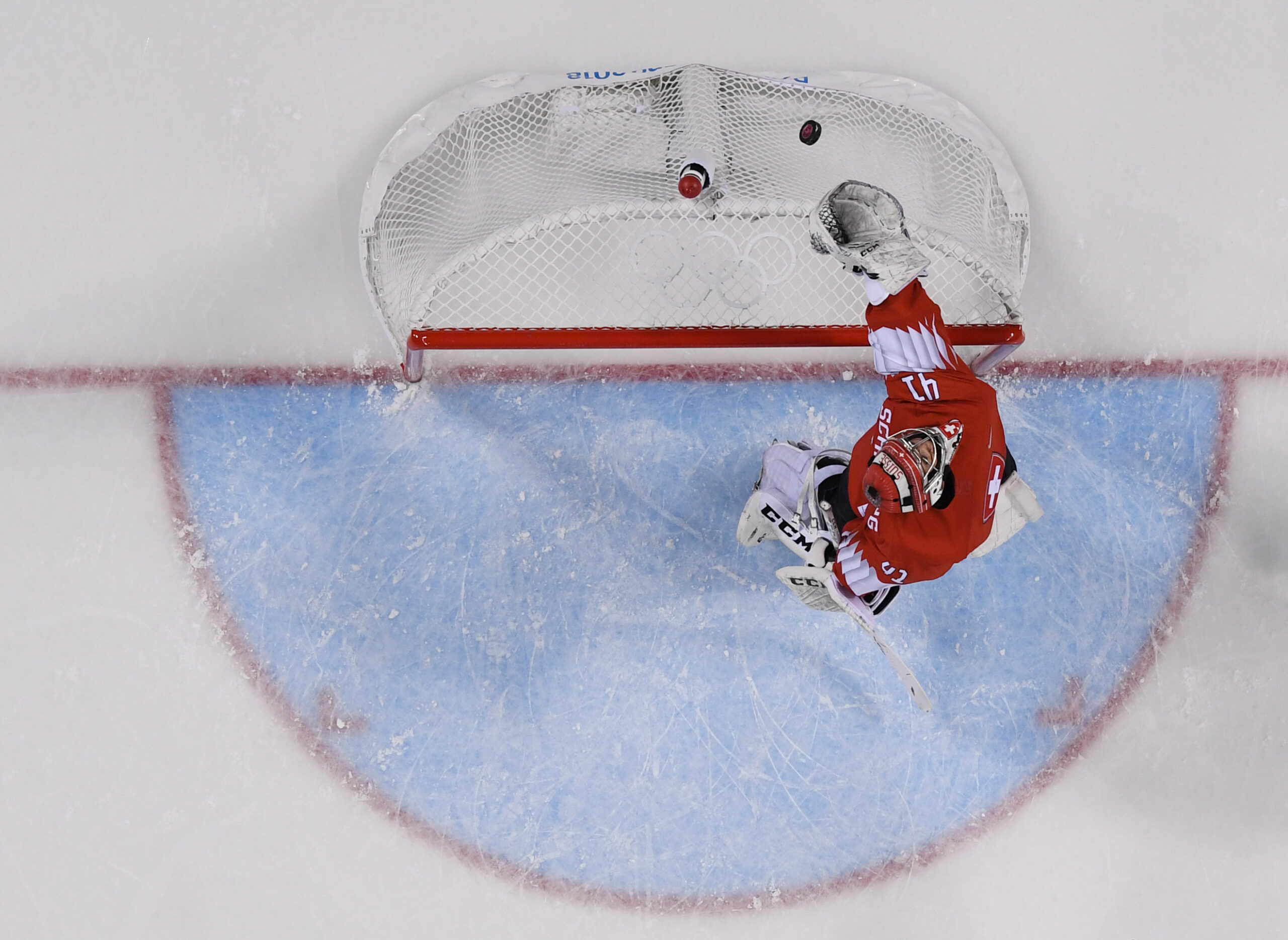Florence Schelling (41) reaches back for the puck in an aerial photo of the net