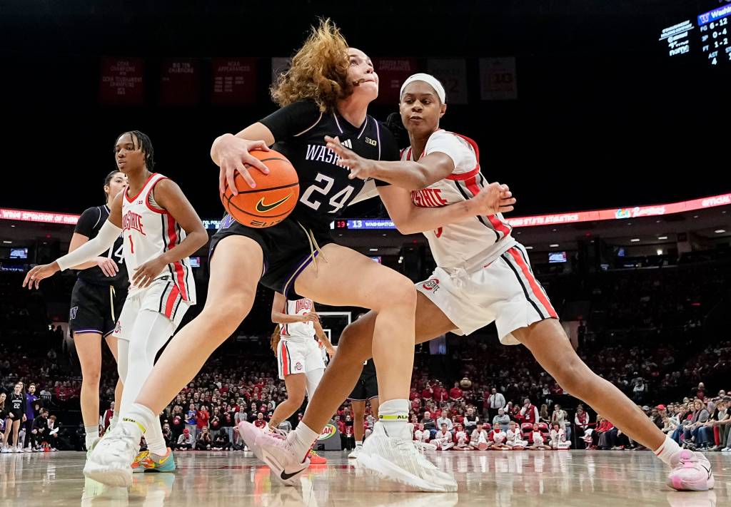 Washington's Elle Ladine wearing black and purple No. 24 Washington Jersey dribbling against Kennedy Cambridge wearing white and scarlet Ohio State jersey. 