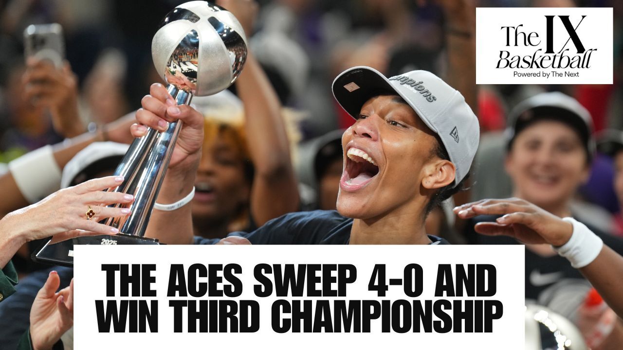 A'ja Wilson of the LAs Vegas Aces raises a trophy in celebration while donning.a grey Champions hat