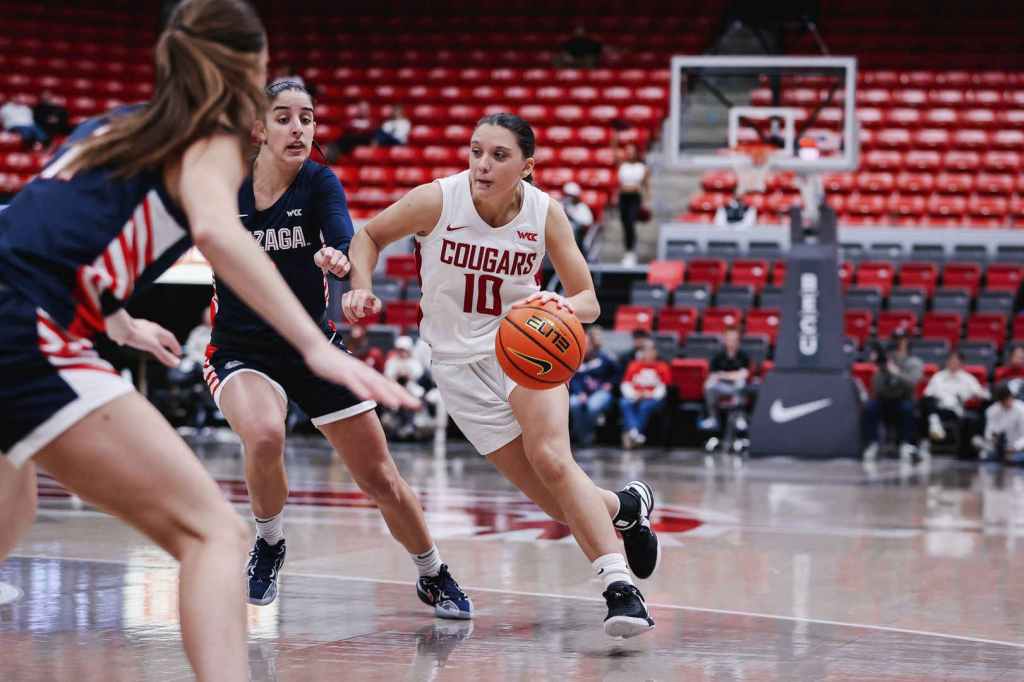 Washington State guard Eleonora Villa drives against Gonzaga. She is shown from the front with two Gonzaga defenders on the left.