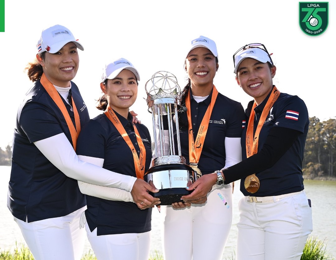 Four members of Team Thailand hold the 2023 Hanwha LIFEPLUS International Crown trophy in the middle of the frame. They wear first place medals around their necks and smile at the camera.