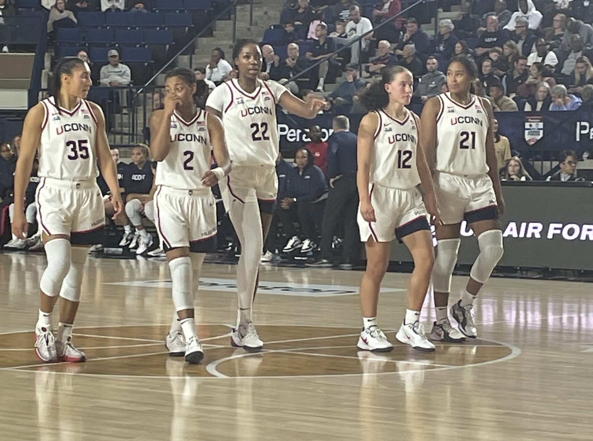 A group of UConn players are walking on the floor during its season-opening victory.