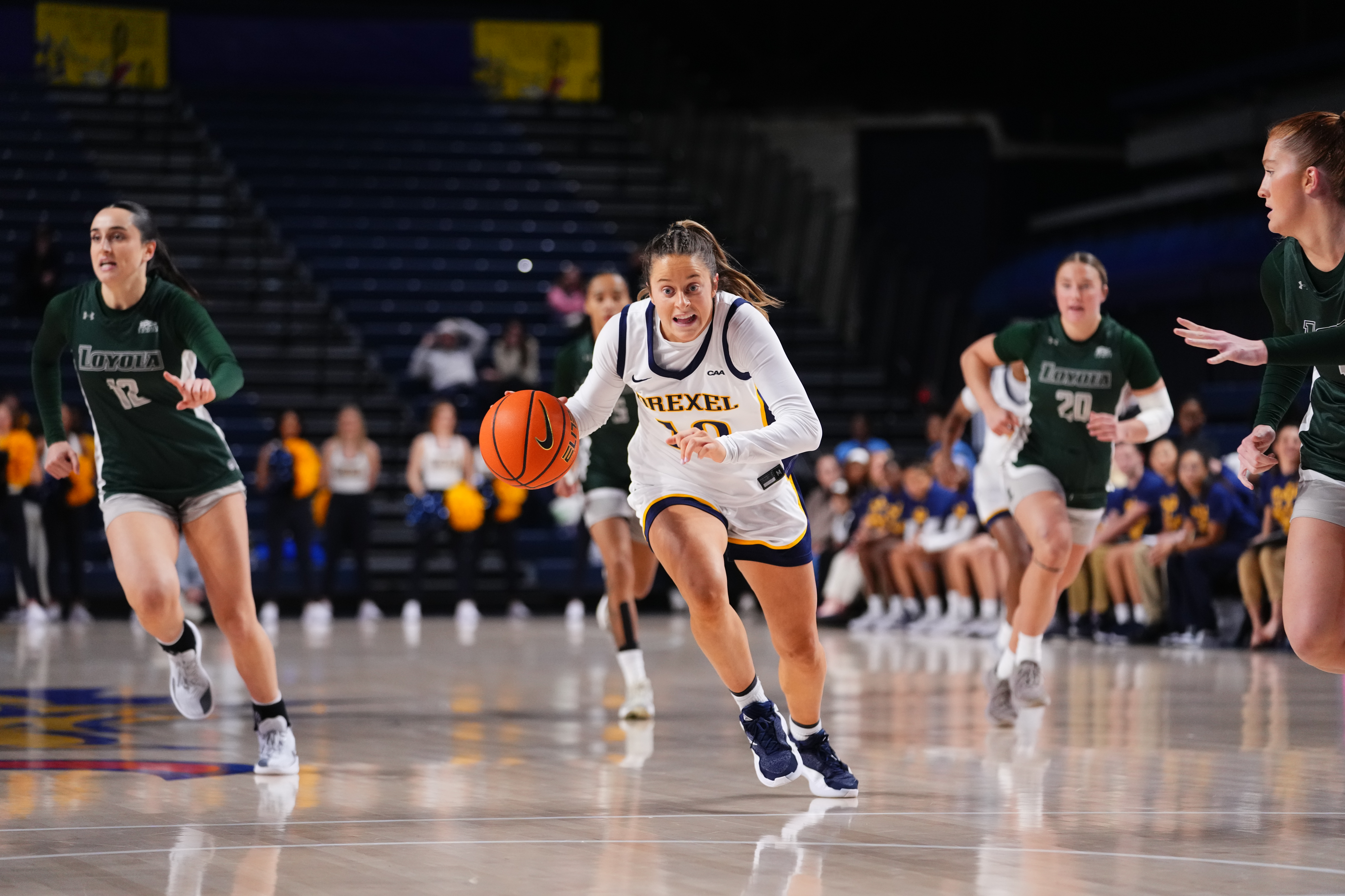 Laine McGurk drives the ball to the basket on a fastbreak.