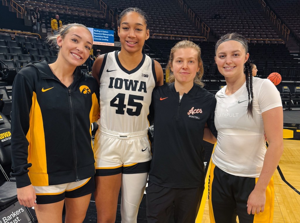 Evansville women's basketball graduate assistant Molly Davis reunites with her former Iowa teammates Kylie Feuerbach, Hannah Stuelke and Taylor McCabe before Evansville's game against Iowa on Nov. 9, 2025 in Iowa City, Iowa.