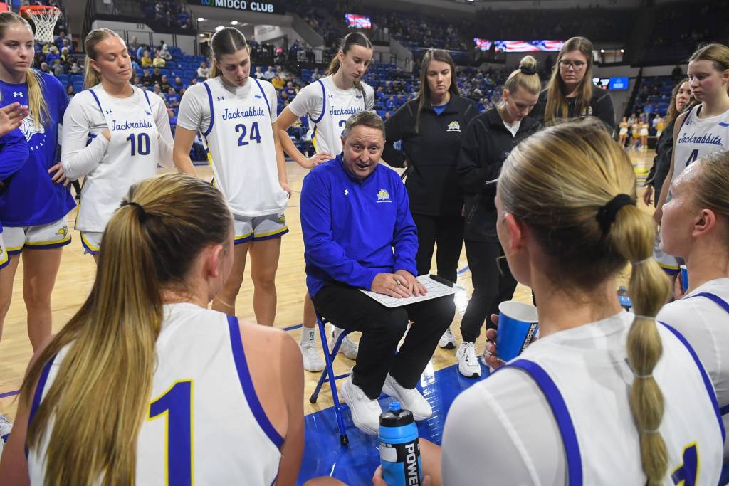South Dakota State women's basketball team discusses next plays in their huddle.