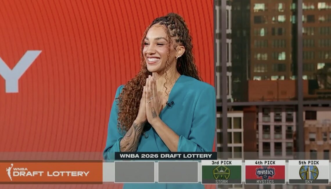Seattle Storm guard/forward Gabby Williams smiles and claps in response to Seattle getting the third overall pick in the 2026 WNBA Draft. She is shown on the broadcast of the draft lottery, and a graphic with the lottery results is overlaid at the bottom.