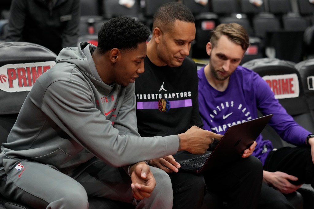 Toronto Raptors assistant coach Jama Mahlalela goes over film with other members of the team.