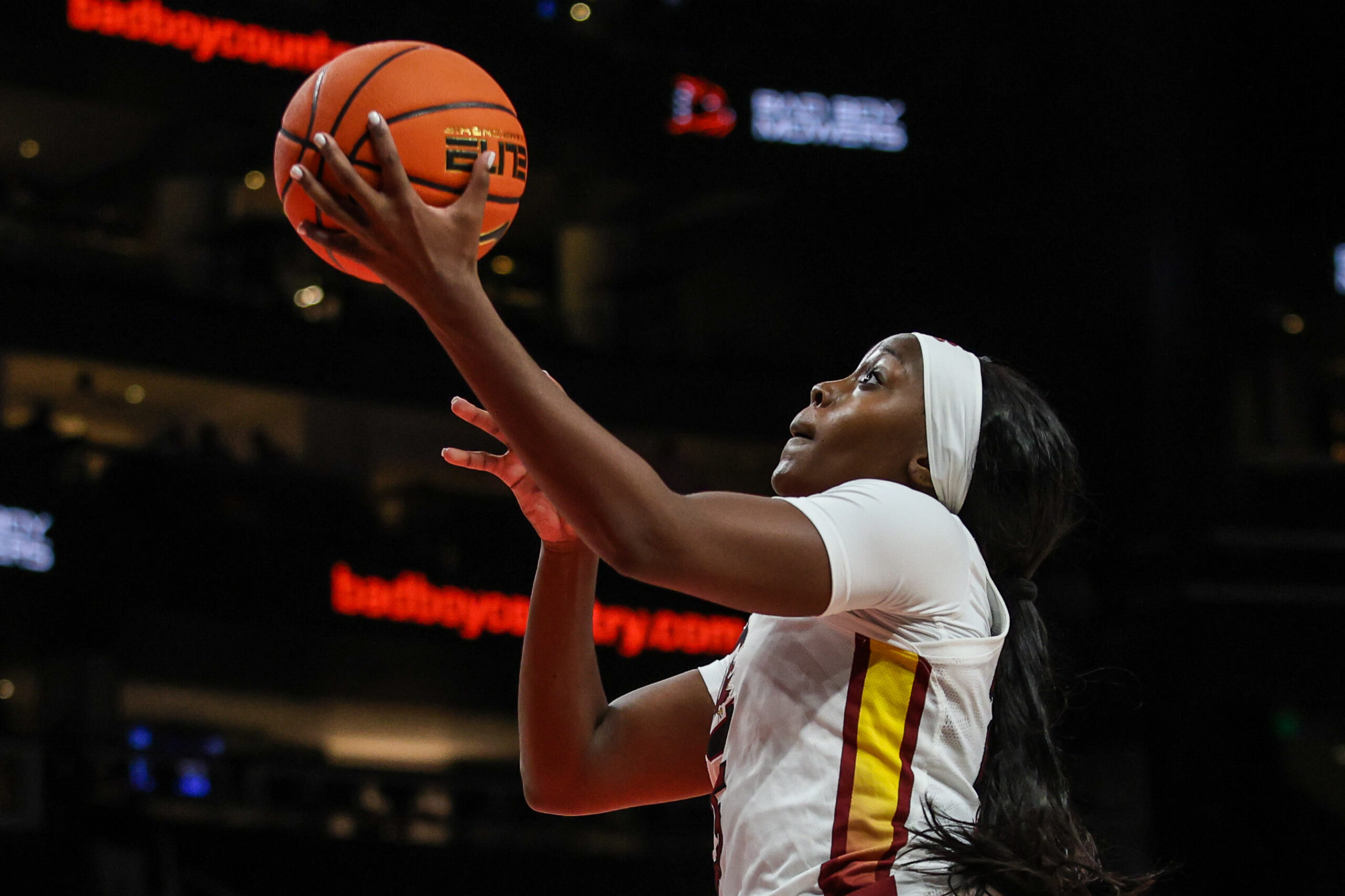 Raven Johnson shoots a left handed layup, eyes on the basket.