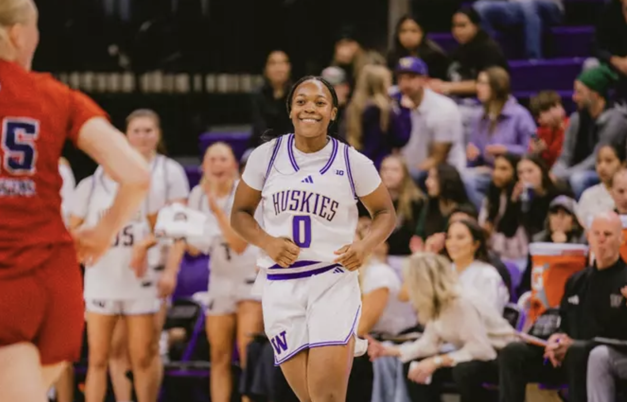University of Washington guard Sayvia Sellers grins and gets back on defense against Fresno State on December 1, 2025, at Alaska Airlines Arena in Seattle, Wash.